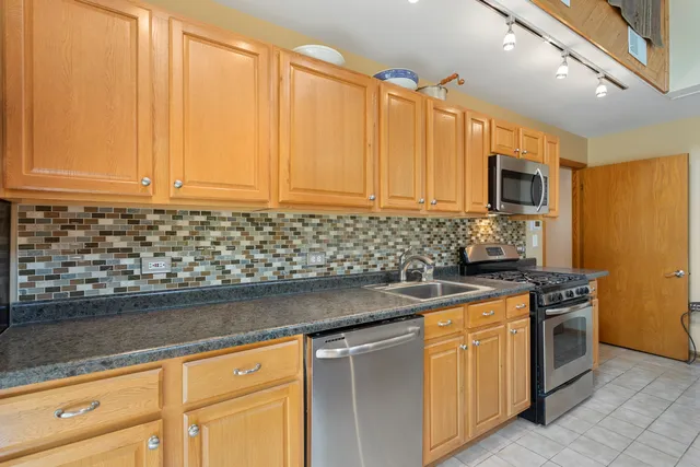 a green field with lots of trees in it