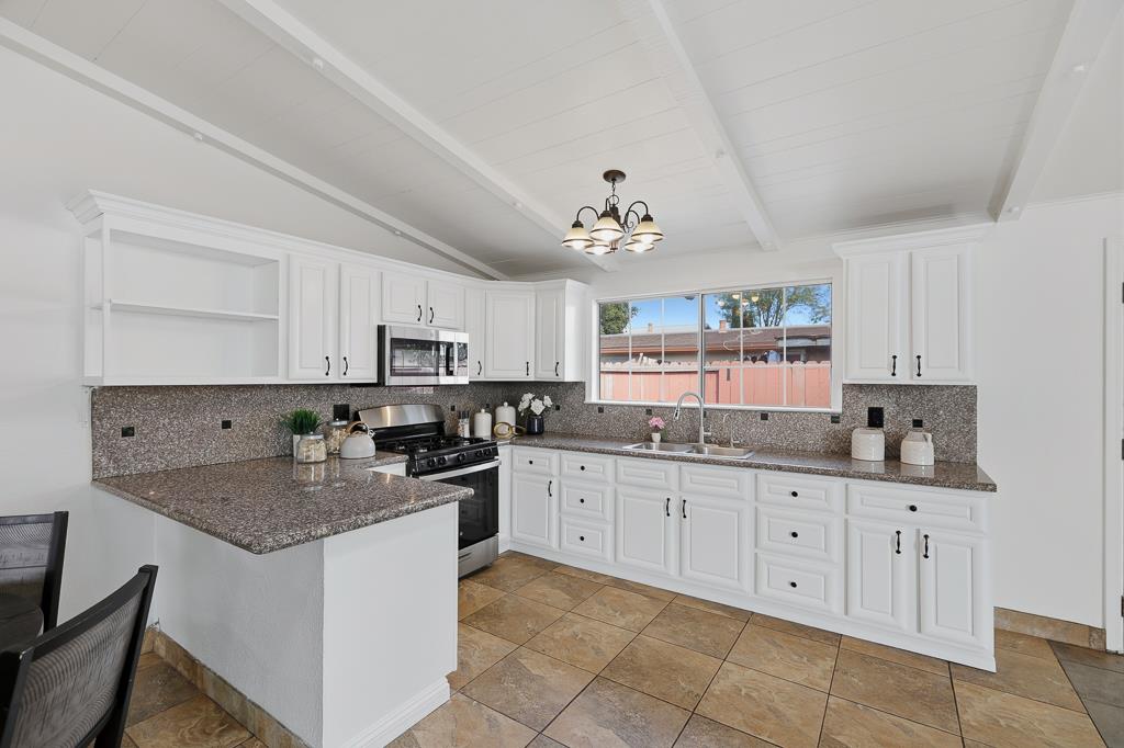 2675 Leeward Street Hayward, CA 94545 - Photo 15 of 75 a kitchen with granite countertop a sink and cabinets