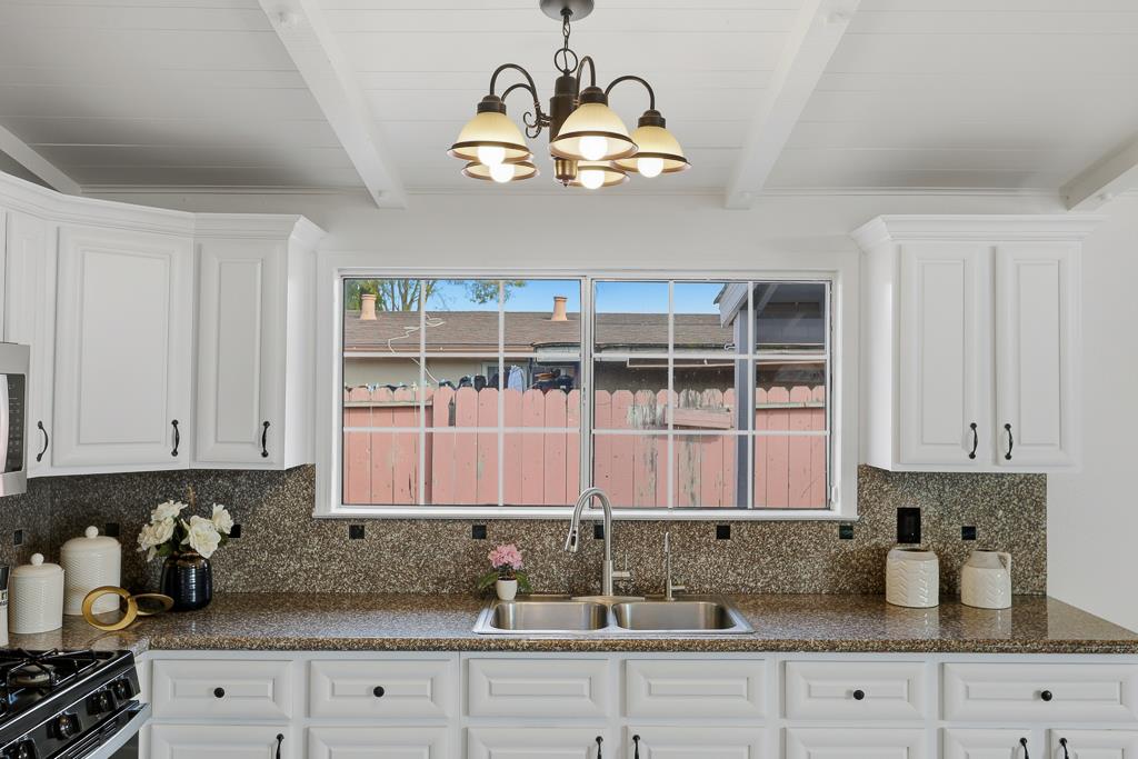 2675 Leeward Street Hayward, CA 94545 - Photo 18 of 75 a kitchen with stainless steel appliances granite countertop white cabinets a window and a counter space