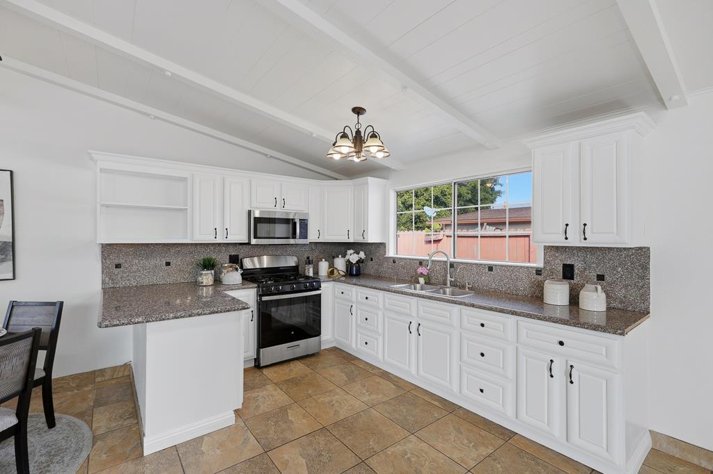2675 Leeward Street Hayward, CA 94545 - Photo 21 of 75 a kitchen with a sink stove top oven and cabinets