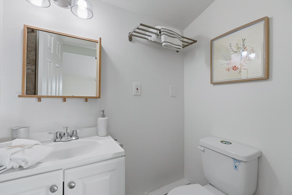 2675 Leeward Street Hayward, CA 94545 - Photo 28 of 75 a bathroom with a toilet sink and mirror