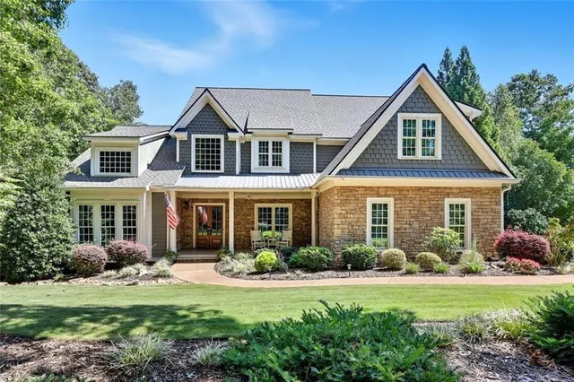 a front view of a house with garden and porch