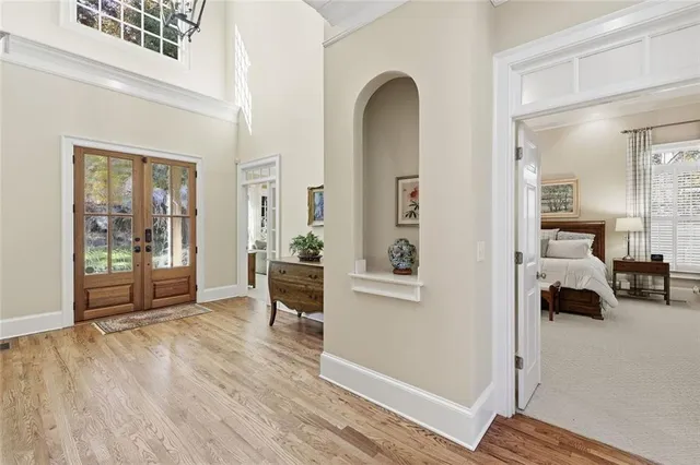a view of a dining room with furniture a chandelier and wooden floor