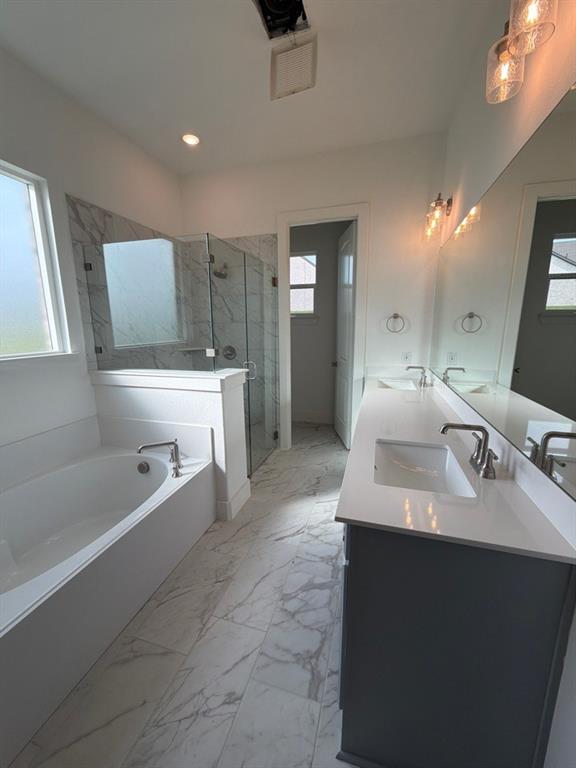 906 Perrin Lane Van Alstyne, TX 75495 - Photo 11 of 14 a spacious bathroom with a double vanity sink a mirror and a bathtub