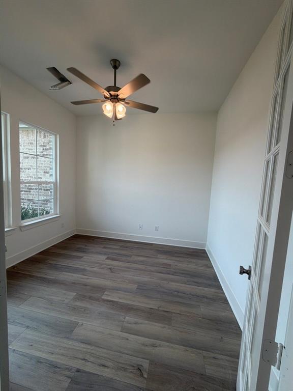 906 Perrin Lane Van Alstyne, TX 75495 - Photo 4 of 14 wooden floor in an empty room with a window