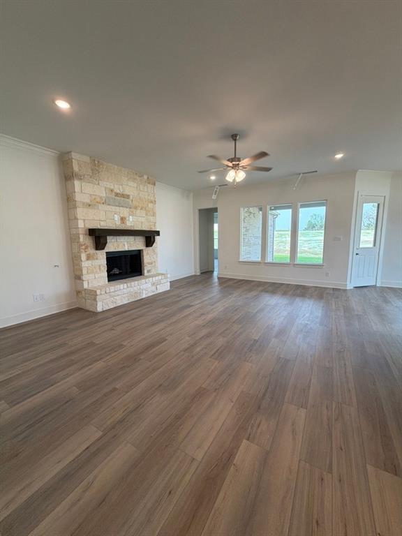 906 Perrin Lane Van Alstyne, TX 75495 - Photo 7 of 14 a view of an empty room with wooden floor and a kitchen