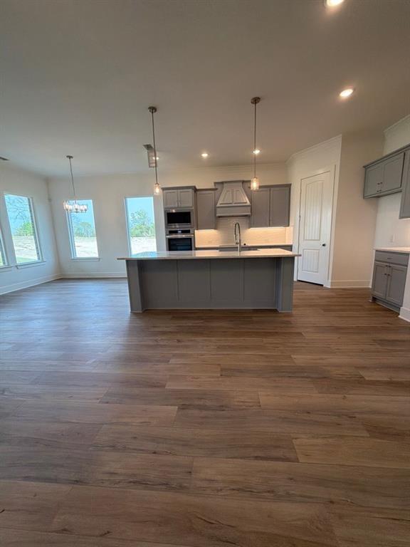 906 Perrin Lane Van Alstyne, TX 75495 - Photo 8 of 14 a large kitchen with kitchen island a sink dishwasher a stove and a refrigerator with wooden floor