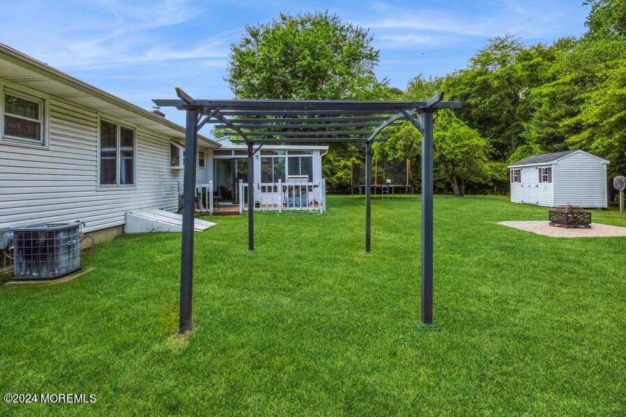 20 Westbrook Road Howell, NJ 07731 - Photo 6 of 6 a view of a backyard with a slide trees and wooden fence