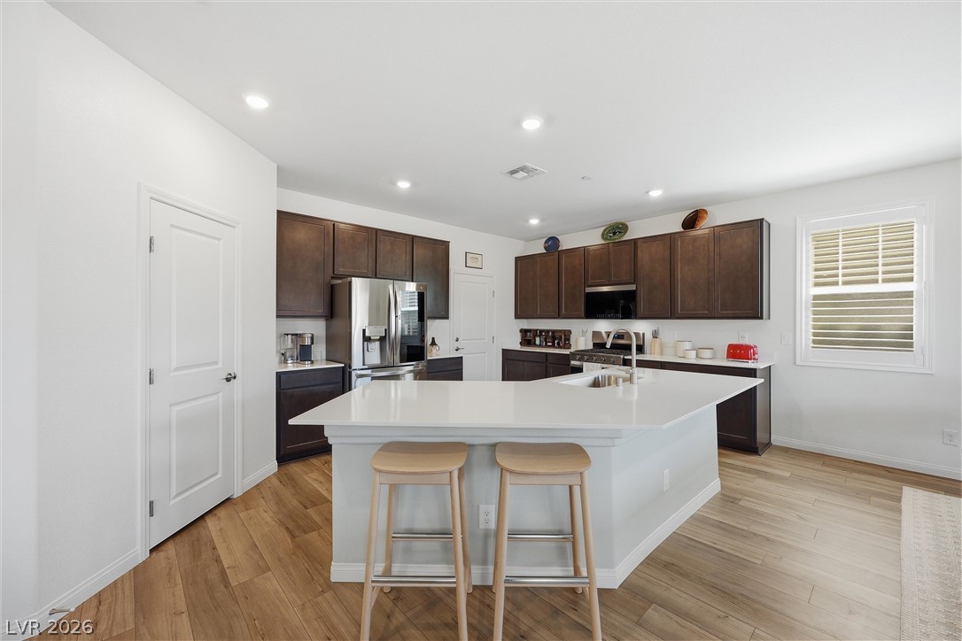 3705 Alla Rocca Avenue Henderson, NV 89044 - Photo 14 of 50 This spacious kitchen offers a large island with seating and modern appliances, perfect for everyday living.