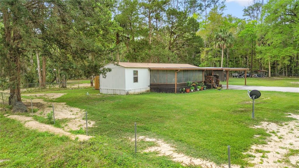 3650 176 Place Inglis, FL 34449 - Photo 49 of 49 a view of a house with a yard and sitting area