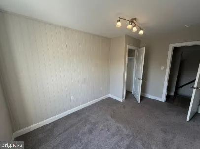 a view of walk in closet with wooden floor