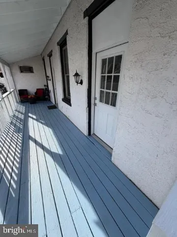 a view of outdoor space with wooden floor and window