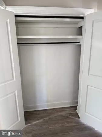 a bathroom with a sink and mirror with toilet