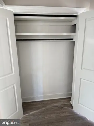 a bathroom with a sink and mirror with toilet