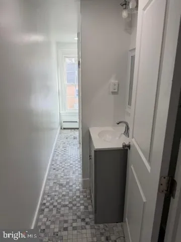 a bathroom with a tub a rug and a shower