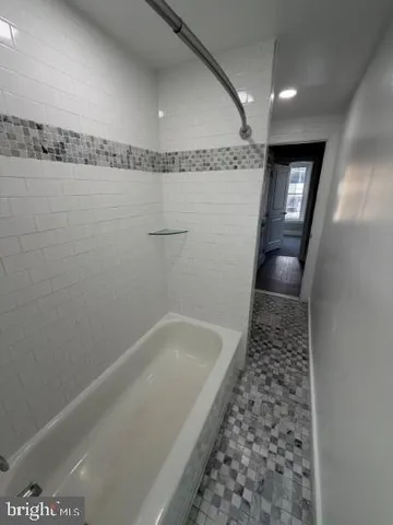 an empty room with windows and entrance