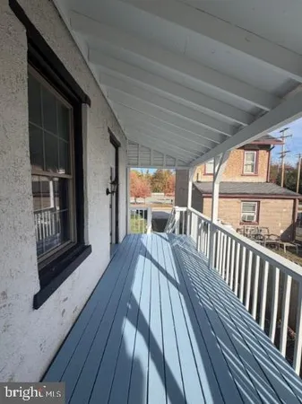 a view of a balcony with wooden floor