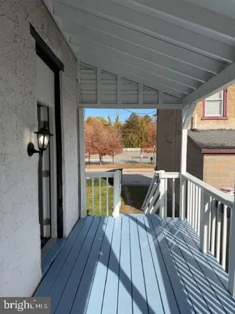 a view of balcony with wooden floor and outdoor seating