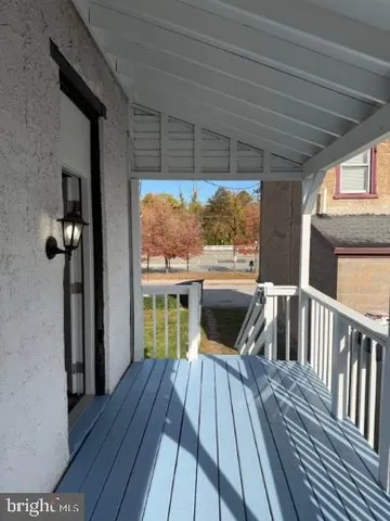 a view of balcony with wooden floor and outdoor seating