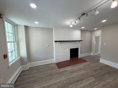 37 Bridge Street, Unit 501 Phoenixville, PA 19460 - Photo 6 of 38 an empty room with wooden floor fireplace and windows