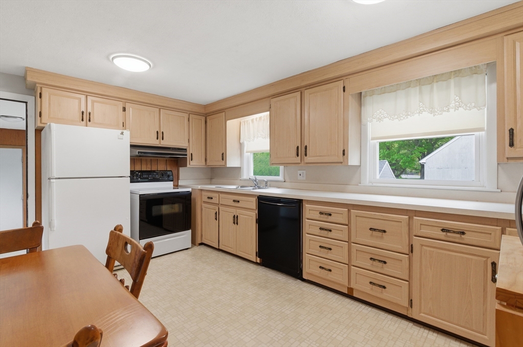 188 Glendale Road Attleboro, MA 02703 - Photo 7 of 37 a kitchen with granite countertop a refrigerator a stove a sink a washer and dryer