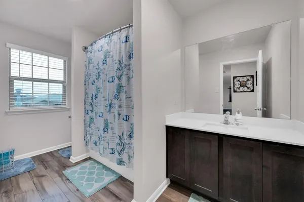 a en suite bathroom with a double vanity sink and a mirror
