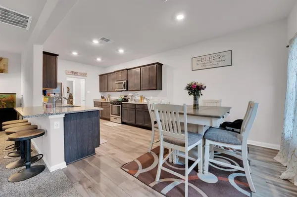 a living room with furniture and view of kitchen