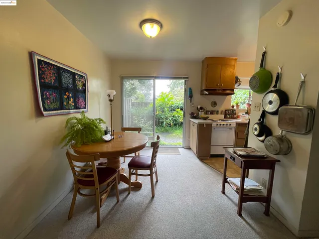 a view of a dining room with furniture and a window