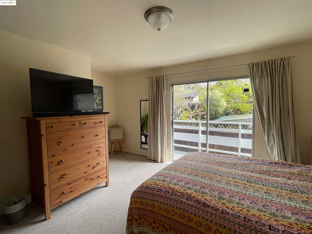 a bedroom with a bed and a television