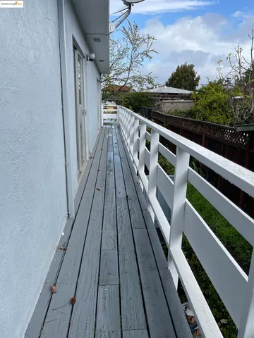 a view of balcony with wooden floor and fence