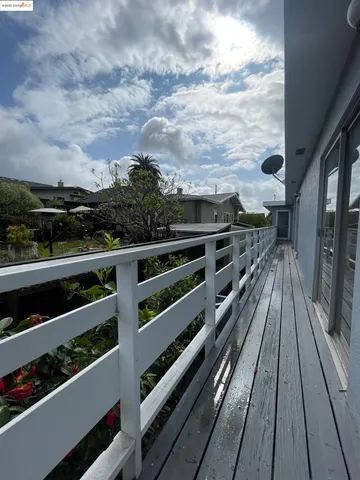 a view of a balcony with wooden floor