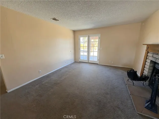 a view of room with window and a fireplace