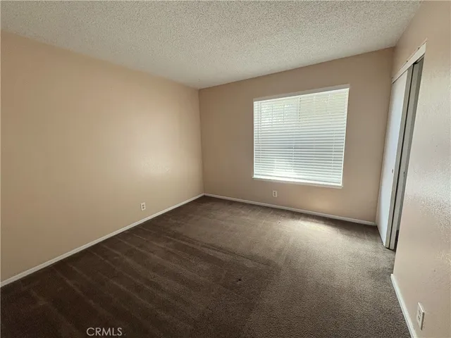 an empty room with a empty space and windows