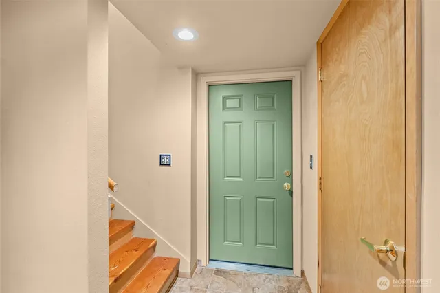 a view of a livingroom with wooden floor and entryway