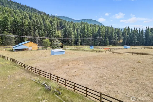 a backyard of a house with table and chairs