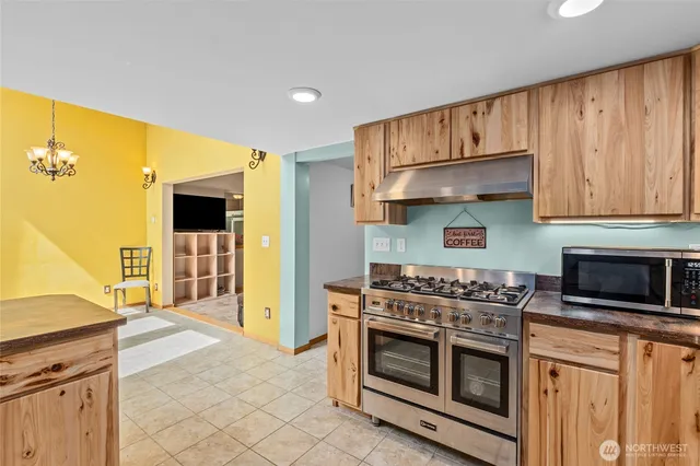 a view of a hallway with a dining table & chairs