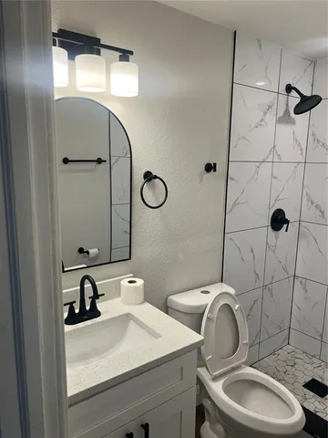 a bathroom with a sink toilet and shower
