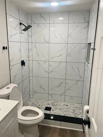 a bathroom with a sink toilet and shower