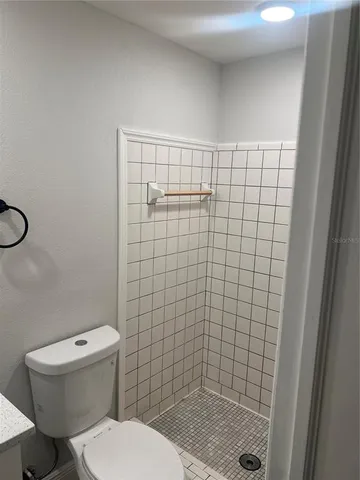 a bathroom with a toilet and a shower