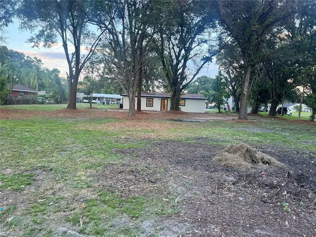 a view of a yard with tree s