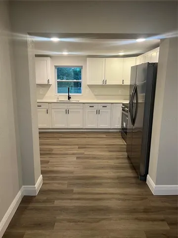 a view of a kitchen from the hallway