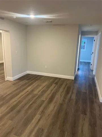 a view of a room with wooden floor