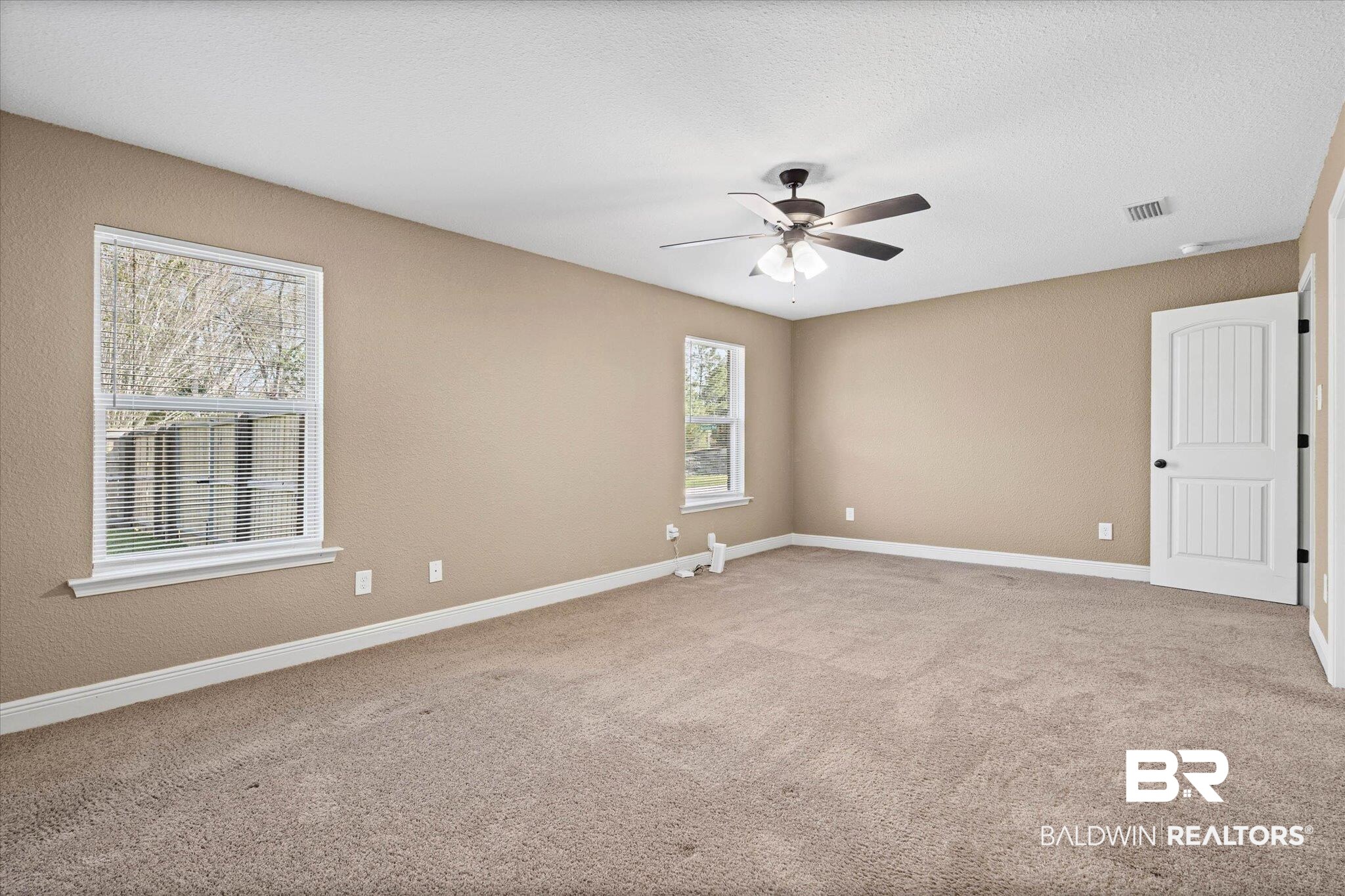 101 Washington Boulevard Foley, AL 36535 - Photo 14 of 32 Spare room featuring ceiling fan, light carpet, and a textured ceiling
