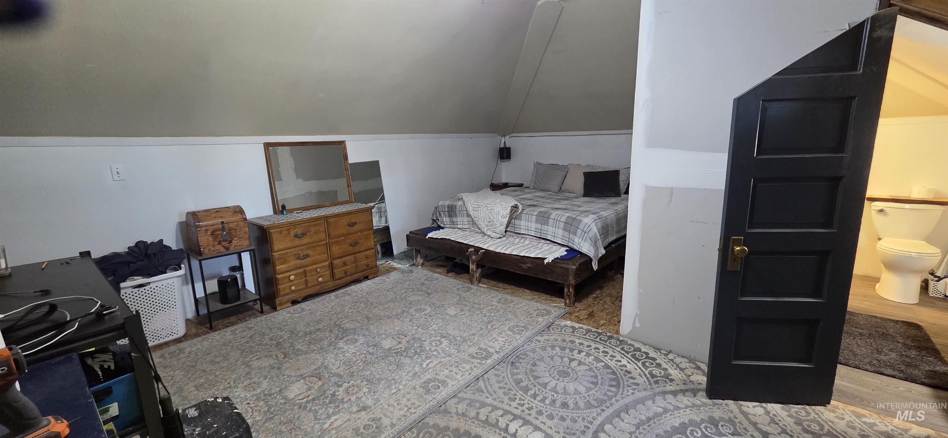 1673 Main Street Pomeroy, WA 99347 - Photo 14 of 26 Bedroom with lofted ceiling and wood finished floors