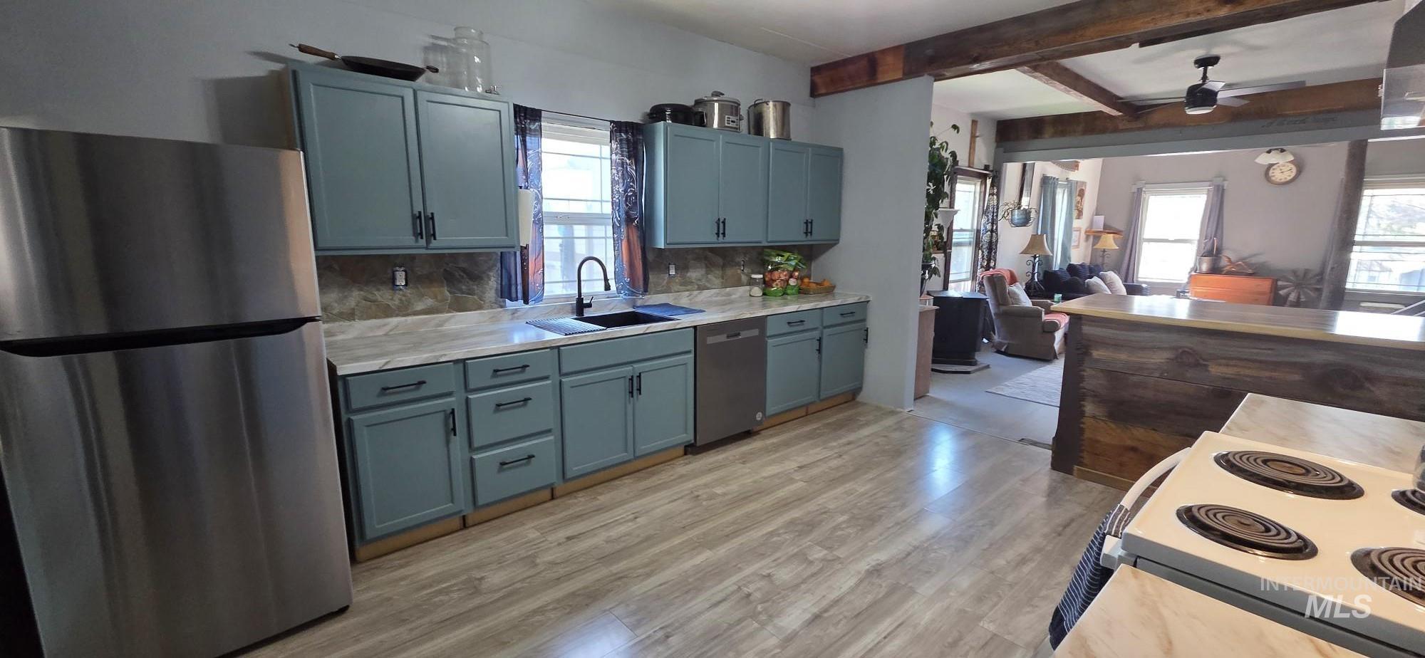 1673 Main Street Pomeroy, WA 99347 - Photo 25 of 26 Kitchen with stainless steel appliances, light countertops, backsplash, a ceiling fan, and open floor plan