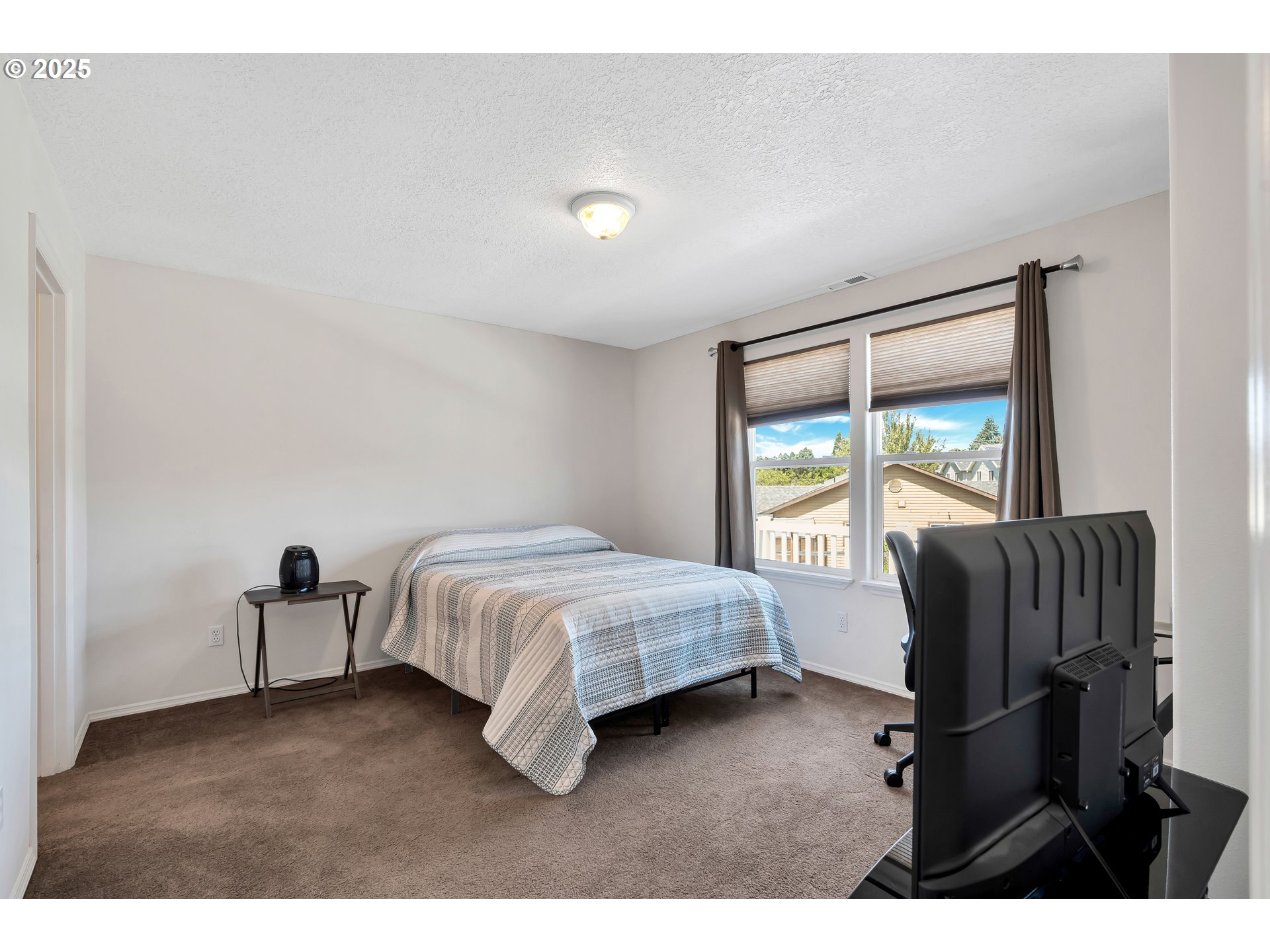 1455 Northeast Jessica Loop Hillsboro, OR 97124 - Photo 19 of 39 a bedroom with furniture and a window