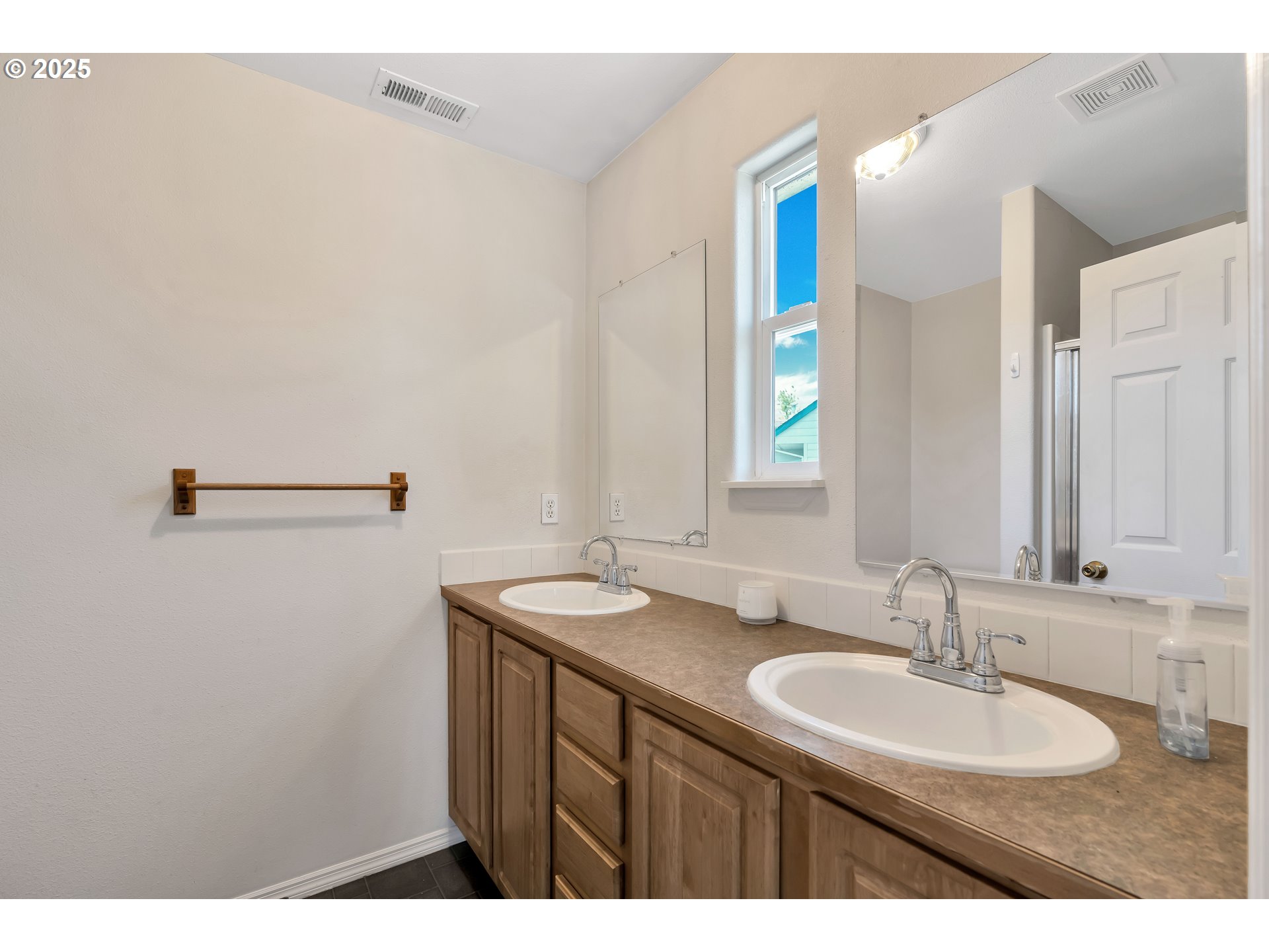 1455 Northeast Jessica Loop Hillsboro, OR 97124 - Photo 21 of 39 a bathroom with a sink and a mirror