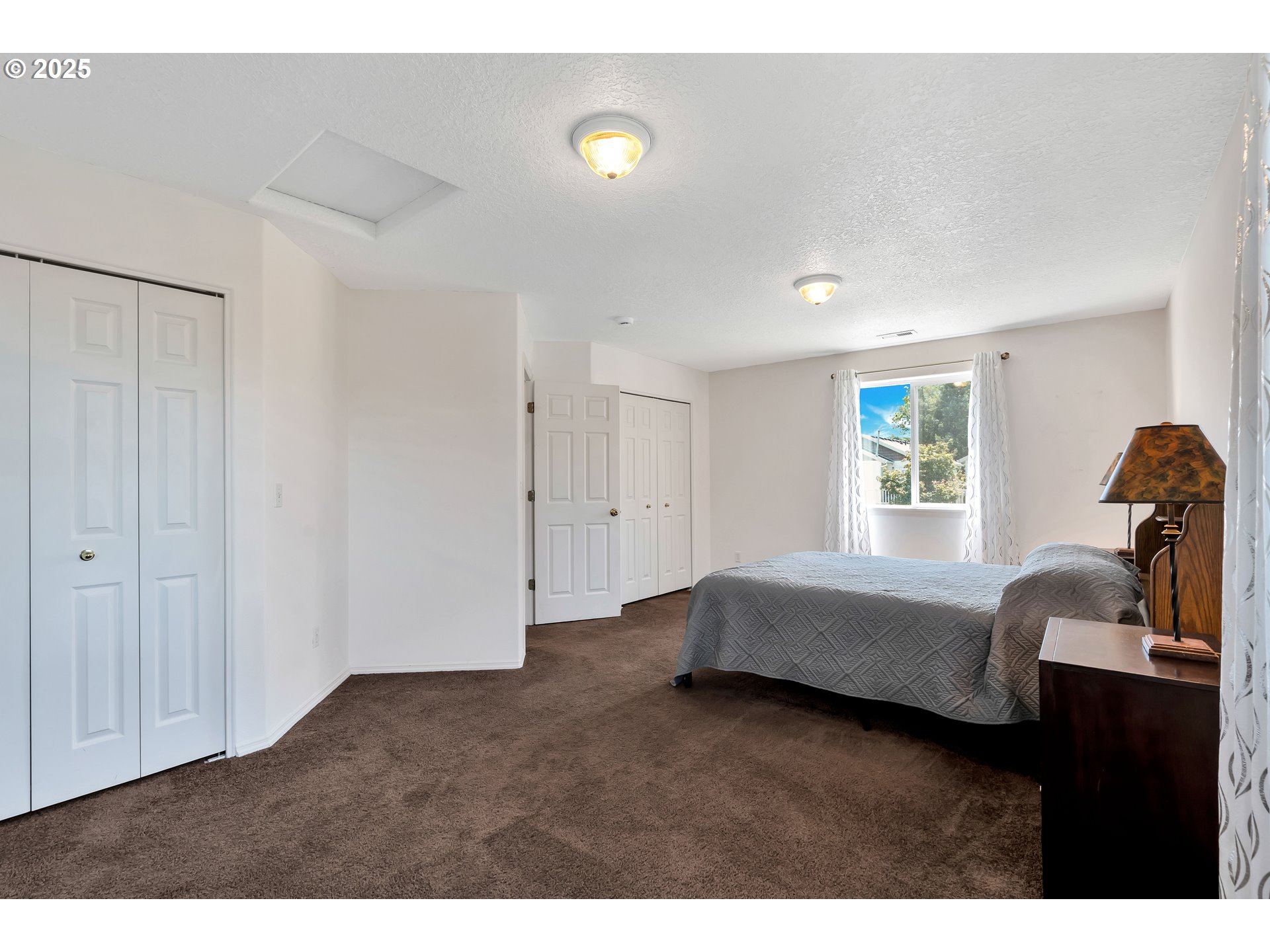 1455 Northeast Jessica Loop Hillsboro, OR 97124 - Photo 26 of 39 a bedroom with furniture and a window