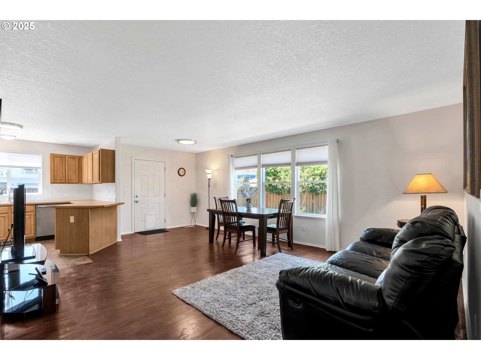 1455 Northeast Jessica Loop Hillsboro, OR 97124 - Photo 6 of 39 a living room with furniture and a dining table