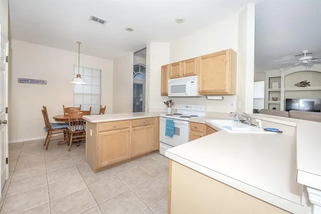 a large kitchen with a table and chairs